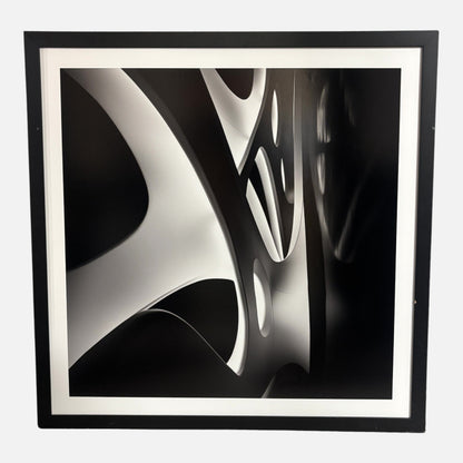 Framed black and white abstract art piece on a white background